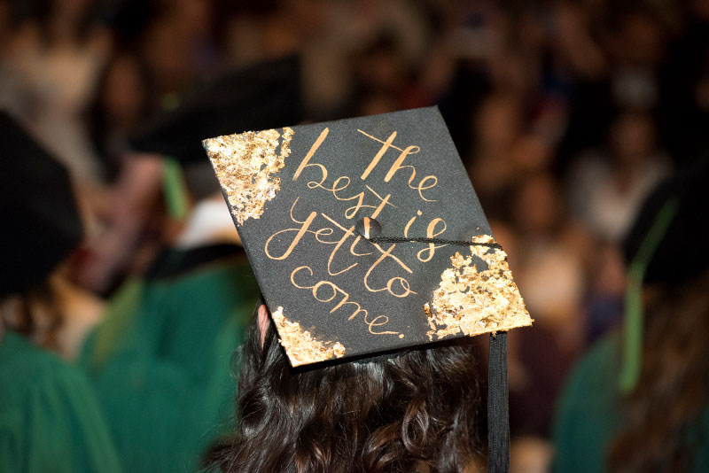A graduating cap with "The best is yet to come" written on it.