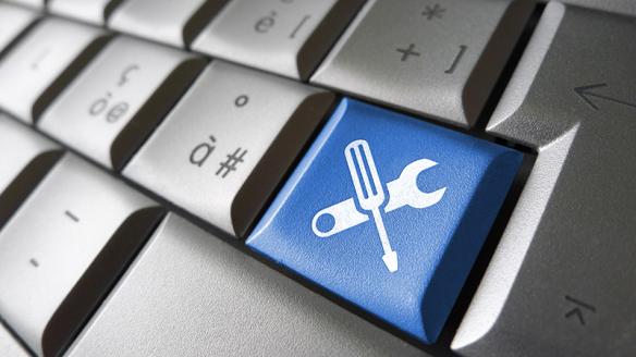 A keyboard with a key that is a wrench and a screwdriver.