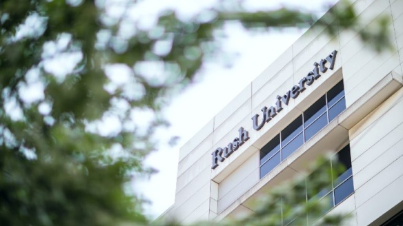 A Rush University building as seen through trees.